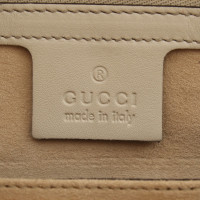 Gucci clutch dans le regard de reptile