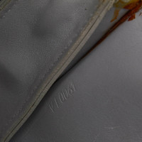 Louis Vuitton Pochette Mini Leather in Beige