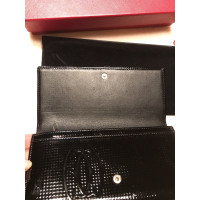 Cartier Handtaschen / Geldbörse aus schwarzem Lackleder