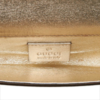 Gucci Clutch aus Leder in Gold