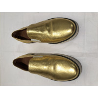 Bottega Veneta Slipper/Ballerinas aus Leder in Gold