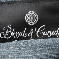 Blessed & Cursed clutch with jeans draping