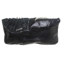Blessed & Cursed clutch with jeans draping