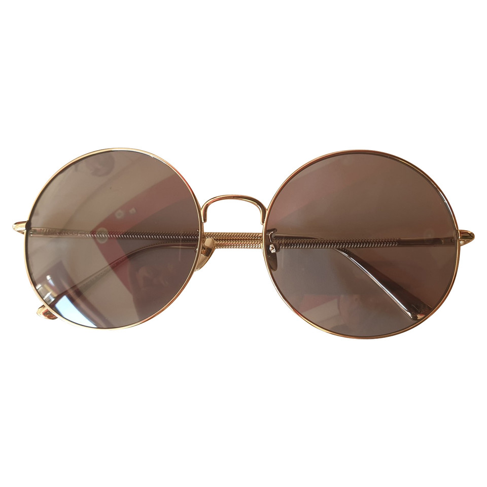 Nina Ricci Sunglasses in Gold