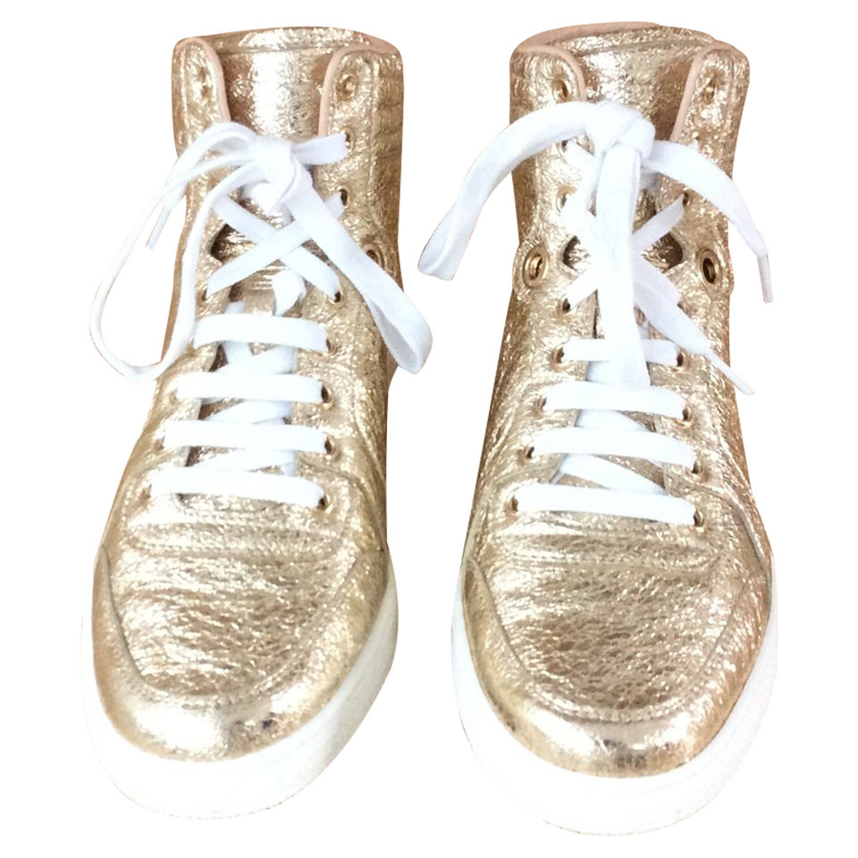 Gucci Sneakers aus Leder in Gold