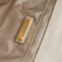 Michael Kors white clutch with golden buckle. 