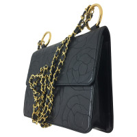 Chanel Chanel in black leather with camellias