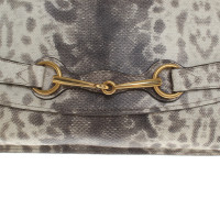 Gucci clutch dans le regard de reptile